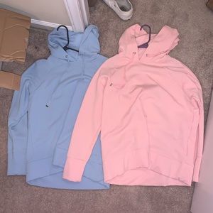 2 pink and blue hoodies